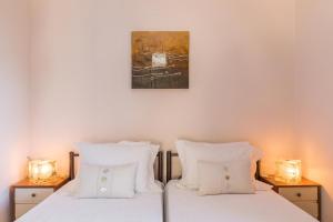 a bedroom with two white pillows and a painting on the wall at Tatiana Seaview House by Konnect, Nisaki in Nisakion