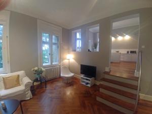 a living room with a white couch and a television at Appartment Sonneck in Freiburg im Breisgau