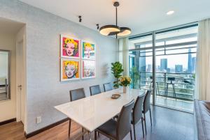 a dining room with a white table and chairs at Spacious Central Apartments for Group and Family - Sailing Tower in Ho Chi Minh City
