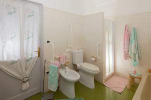 a small bathroom with a toilet and a shower at Casa Zafferano in Albenga +42 photos