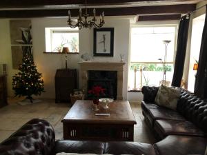 a living room with a couch and a christmas tree at The Pelgrim House in Sint Jacobiparochie