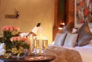 a table with candles and flowers on a bed at The IBNII - Eco Luxury Resort in Madikeri