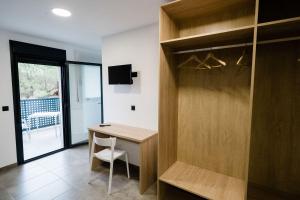 a home office with a wooden desk and a window at Pensión La Buena Vida in Caspe