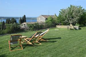 two chairs and a table in a yard at Hostel Panorama Portorož in Portorož