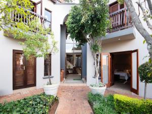 a house with a brick walkway in front of it at Bohemian House - Pretoria in Pretoria