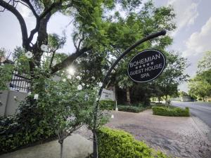 a sign for a guest house sign on a street at Bohemian Guesthouse - Pretoria in Pretoria