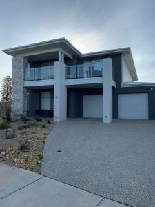 a house with a large driveway in front of it at Bunya By The Sea in Cape Woolamai