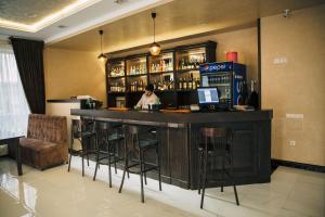 a bar in a restaurant with a person behind the counter at Роляда in Tysmenytsya