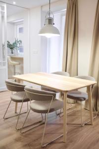 a dining room table with chairs and a light fixture at Apartment Alaitz Rentería in Rentería