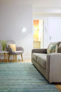 a living room with a couch and a chair at Apartment Alaitz Rentería in Rentería