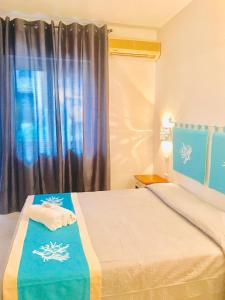 Postel nebo postele na pokoji v ubytování Hotel Sandalion
