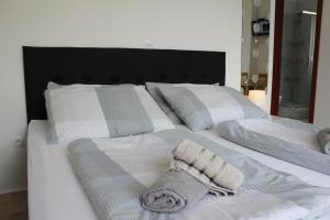 a white bed with a blanket and pillows on it at Villa Marina in Omiš