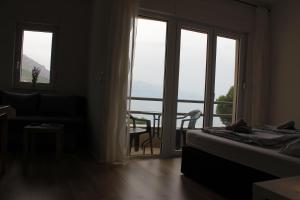 a bedroom with a bed and a balcony with a table at Villa Marina in Omiš