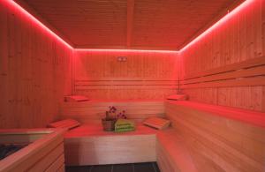 a sauna with red lights in a wooden room at Eurocamp Spreewaldtor in Groß Leuthen +49 photos