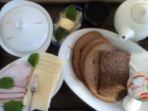 a white plate of food with a sandwich and cheese at Zöllnerhaus Nordhorn in Nordhorn +8 photos