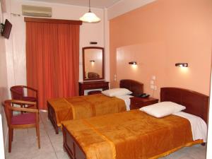 a hotel room with two beds and a mirror at Hotel Cosmos in Athens