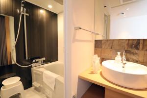 a bathroom with a sink and a toilet and a tub at Stay SAKURA Kyoto Gion Miyagawacho in Kyoto