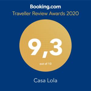 a yellow circle with the number nine and the text travelling review awards at Casa Lola in Agaete
