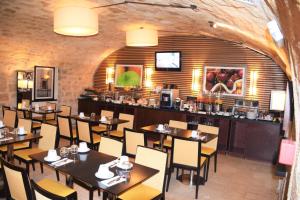 a restaurant with tables and chairs and a bar at Folkestone Opéra in Paris +43 photos