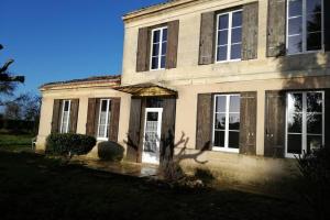 una casa vieja con la puerta principal abierta en Belle demeure avec espaces verts en Gauriac