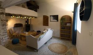 a living room with a couch and a table at Le Mas Bellane in Salettes