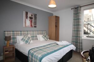 A bed or beds in a room at White Hart Hotel 