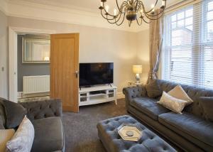 a living room with a couch and a television at Host & Stay - Simba House in Saltburn-by-the-Sea
