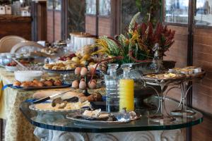 a table topped with plates of food and drinks at Hotel Riviera Venezia Lido in Venice-Lido