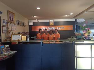 a group of people standing behind the counter of a restaurant at Amarin Samui Hotel - SHA Plus Certified in Mae Nam +34 photos