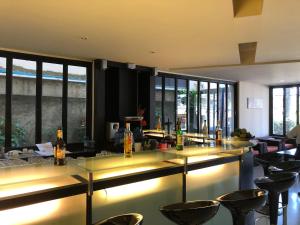 a bar with yellow counter tops and bar stools at Amarin Samui Hotel - SHA Plus Certified in Mae Nam
