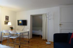 a room with a table and chairs and a bedroom at Villa Elisabeth Apartments in Pärnu