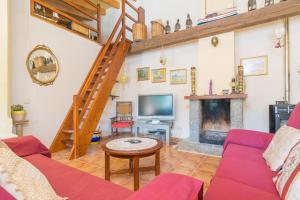 a living room with a couch and a fireplace at Es Blanquer De Na Fani in Binissalem