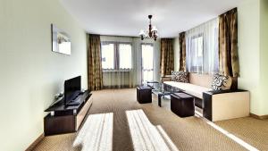 a living room with a couch and a tv at Family Complex KrisBo in Donkovtsi