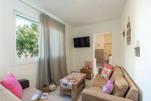 a living room with a couch and a window at Sweet Home Kremasti in Kremasti