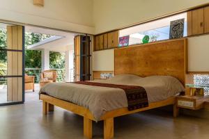 a bedroom with a large bed with a large window at Spacious 3BR Daveys Townhouse with Private Lawn Pet Friendly and Complimentary Breakfast in Mysore