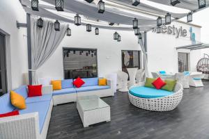 a living room with couches and colorful pillows at Lifestyle18 Hotel and Shortlet Apartments in Lagos