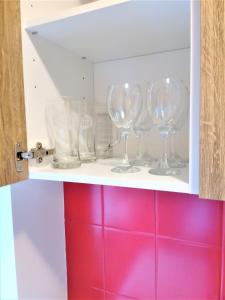 a row of wine glasses on a shelf at Studio Daola in Gdańsk