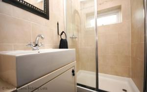 a bathroom with a sink and a shower at Springwell , West Wittering in West Wittering +32 photos