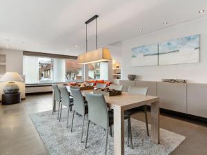 a kitchen and dining room with a table and chairs at Elegant Holiday Home in De Panne with Sauna in De Panne