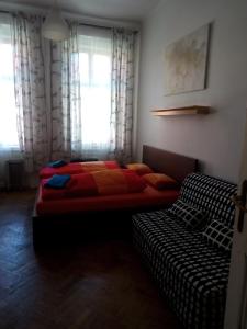 a bedroom with a bed and a couch in it at Apartmány Železná in Prague