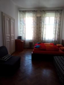 a bedroom with a bed with a red blanket at Apartmány Železná in Prague