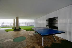 a ping pong table in the middle of a room at Beautiful cozy seaside Apartment AQUARELLE in Calpe in Calpe
