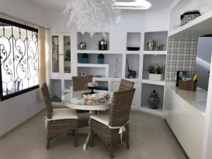 a dining room with a table and wicker chairs at Casa MoJo in Puerto del Carmen