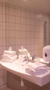 Hotel Montebello في أوسلو: حمام مع حوض عليه مناشف