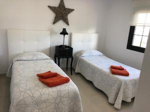 a bedroom with two beds and a star on the wall at Casa MoJo in Puerto del Carmen +13 photos