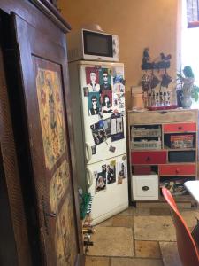 a refrigerator with pictures on it next to a dresser at Appartement Centre Ville Bastia in Bastia