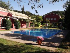 a house with a swimming pool in the yard at Villa De Loulia in Peroulades