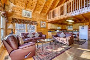 a living room with leather couches and a table at Moonlight Retreat in Pigeon Forge