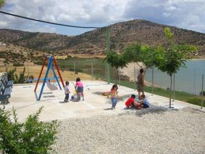 a group of children playing in a playground at Kalados -Beachfront Studios & Restaurant - in Kalando +153 photos