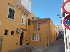 a yellow building on the side of a street at Vico Spina 5 in Milazzo